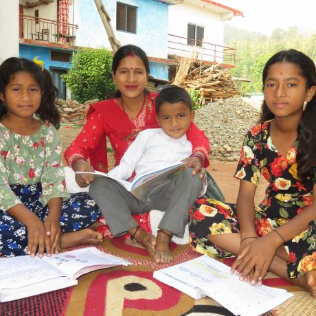 Shanti helping her children to do homework 
