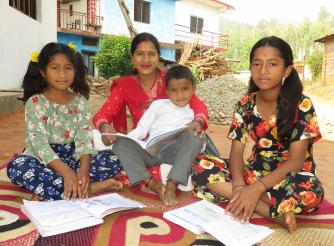 Shanti helping her children to do homework 
